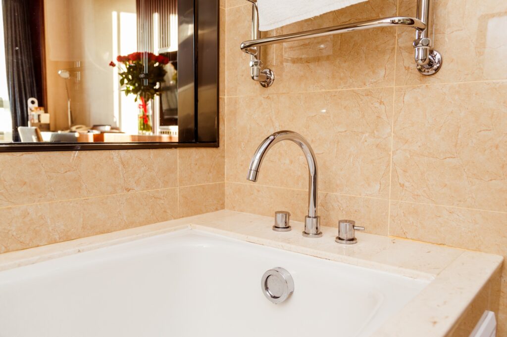 Luxury bath tub and faucet with water.